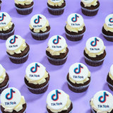 Corporate Cupcakes with Logos featuring chocolate cupcakes topped with edible TikTok logo plaques by Crumbs & Doilies.